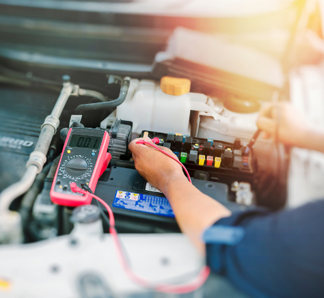 Mechanic working on automotive electrical components
